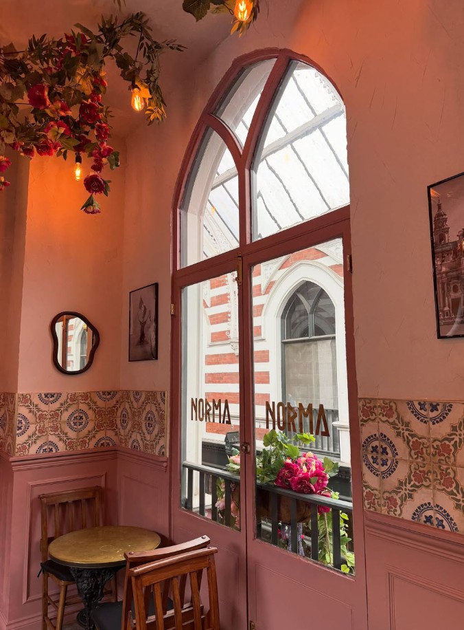 Norma's intimate dining room with an arched window and floral lighting